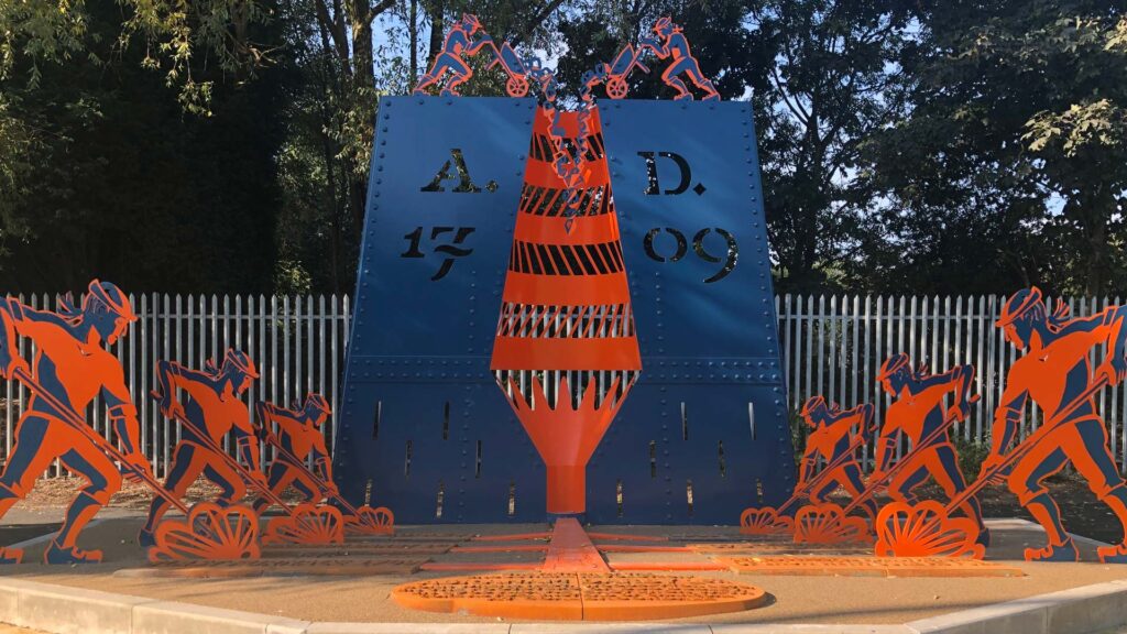 Abraham Darby monument with laser cut panels in Sedgley