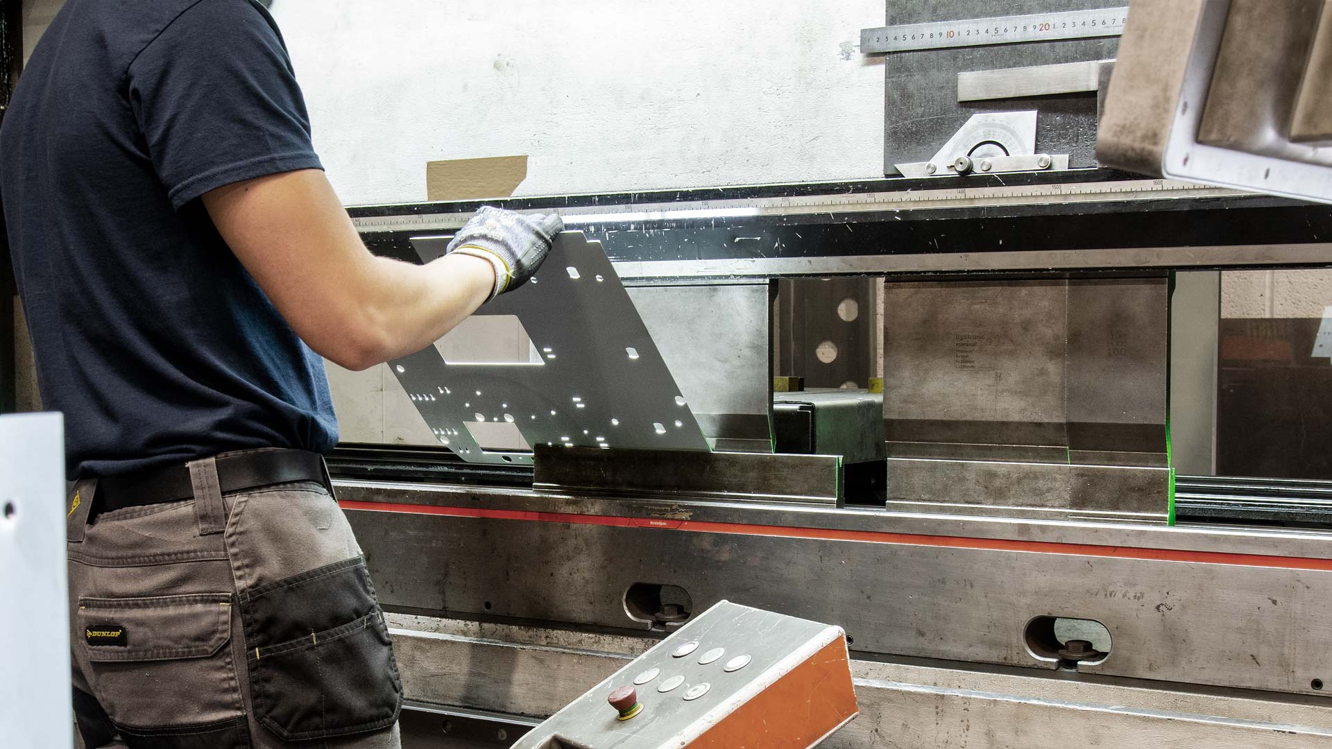 Action shot of man folding metal on 250T press