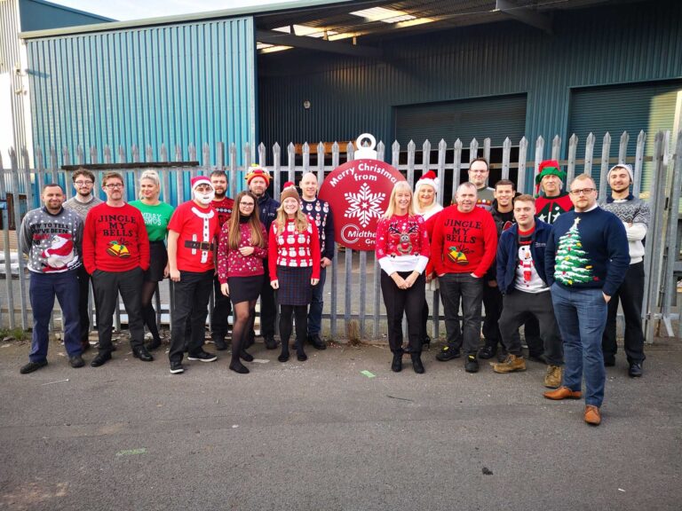 group of employees wearing Christmas jumpers