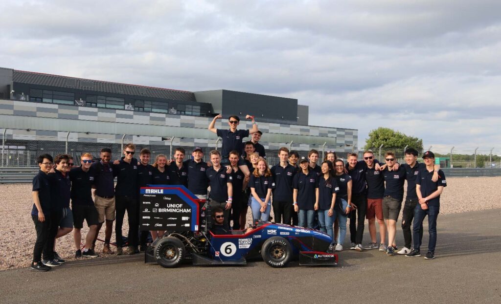 group of university students with race car