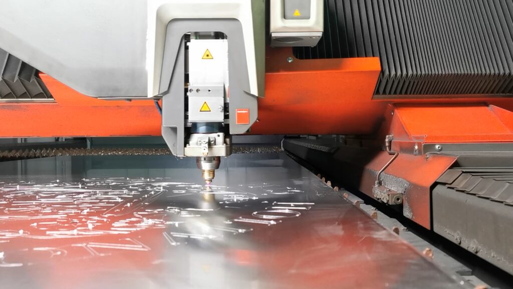 An in machine photo of the intricate panel being cut