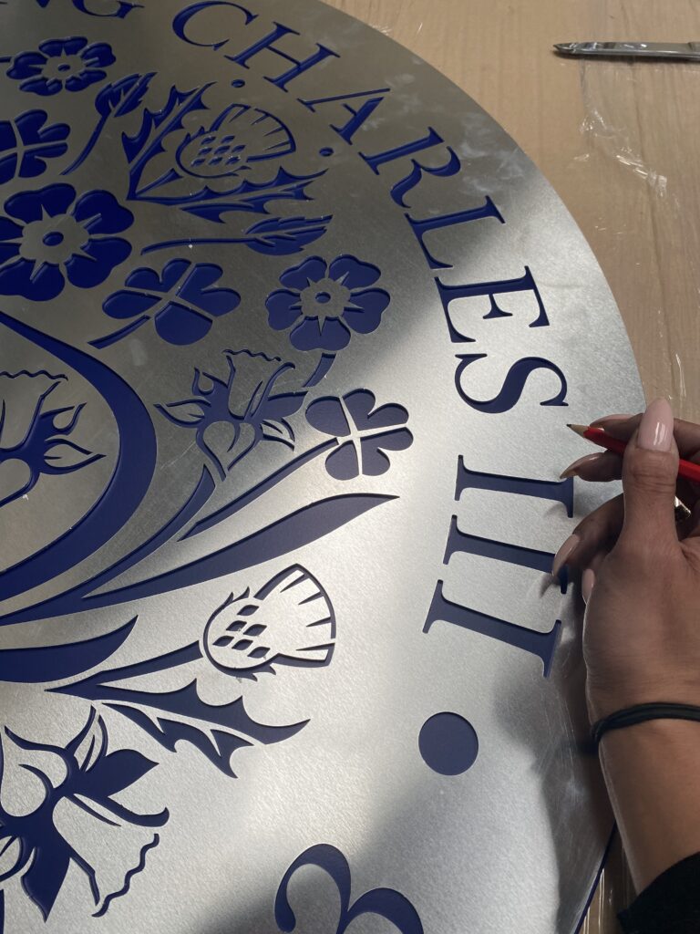 Masking off the panel to ensure the powder coating colours are in the right place