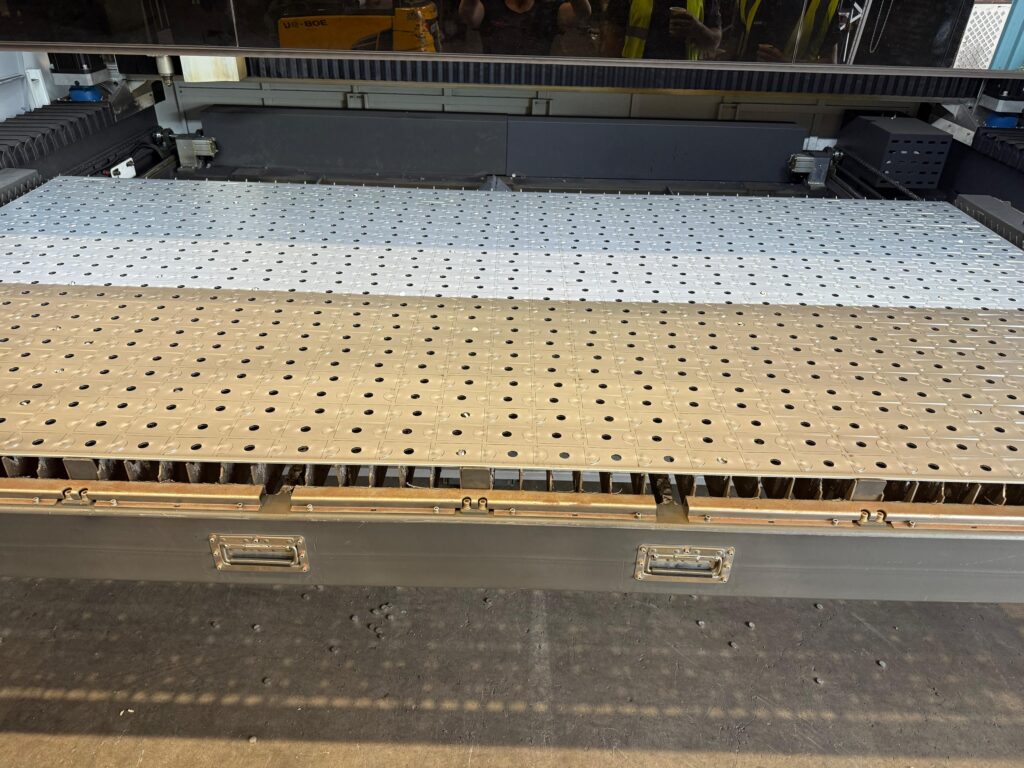An image showing Common Laser Cutting Questions Answered - a bed full of parts