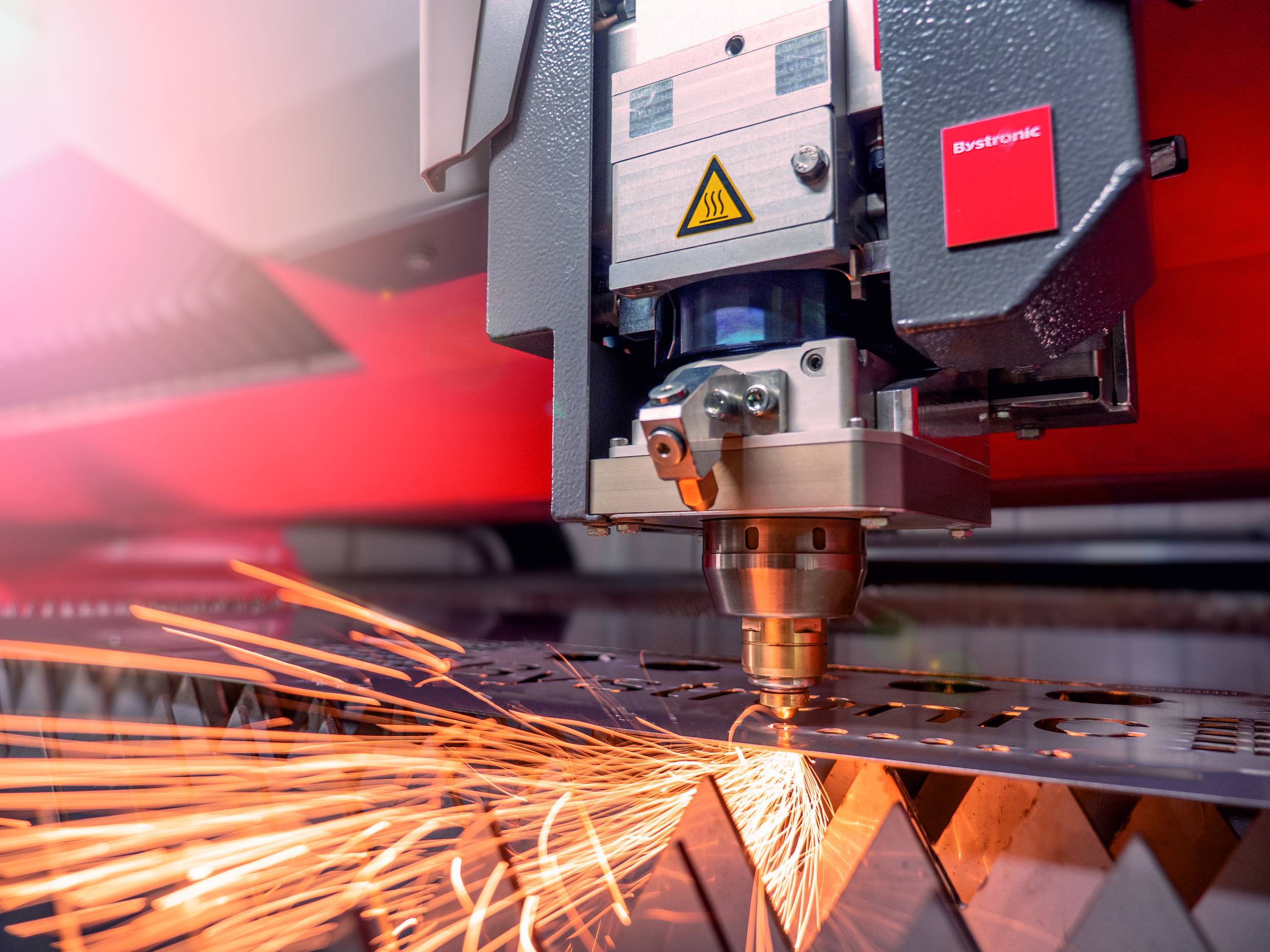 An example of the laser head while laser cutting with sparks flying