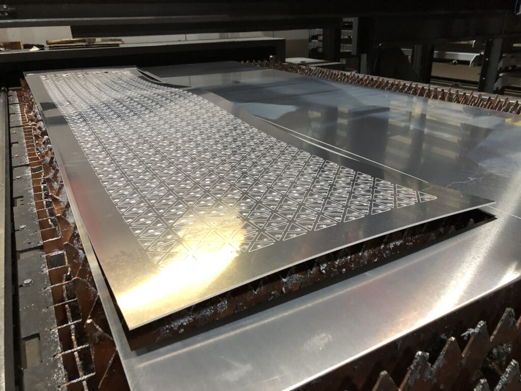Warping of a perforated panel on the machine bed to show poor quality example