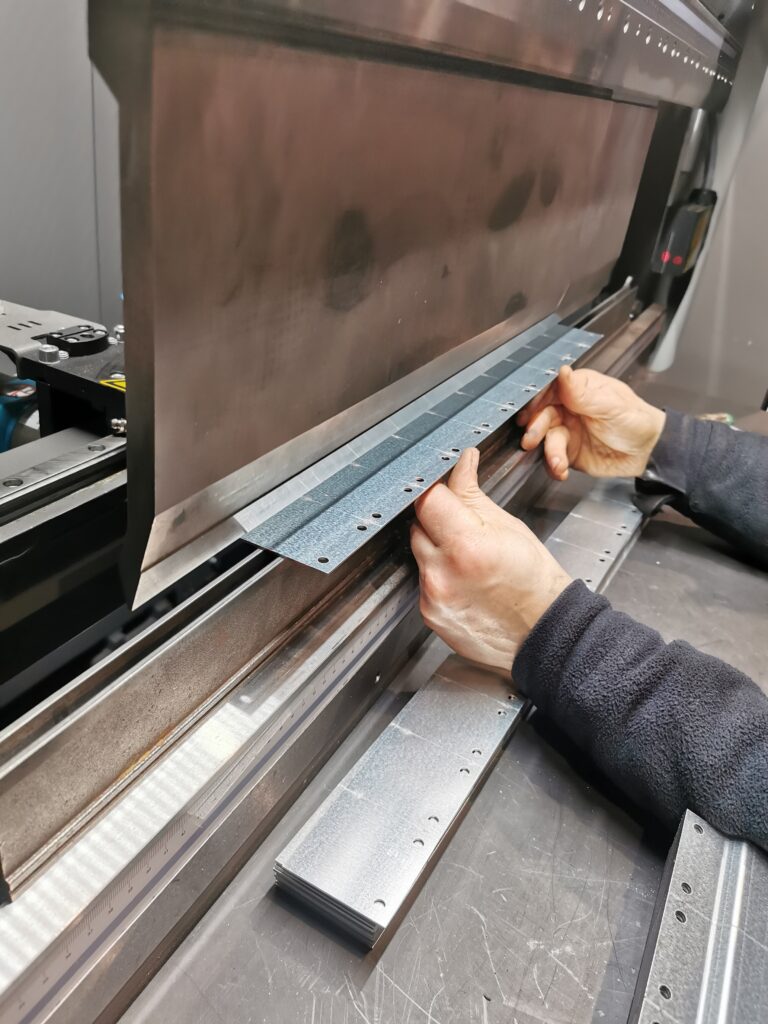A photo of common line cut parts being formed for large batch work