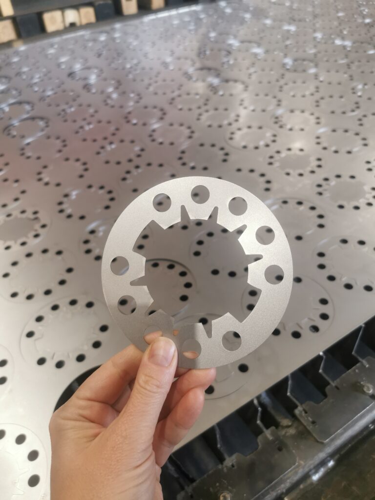 An image showing Common Laser Cutting Questions Answered - parts being visually inspected