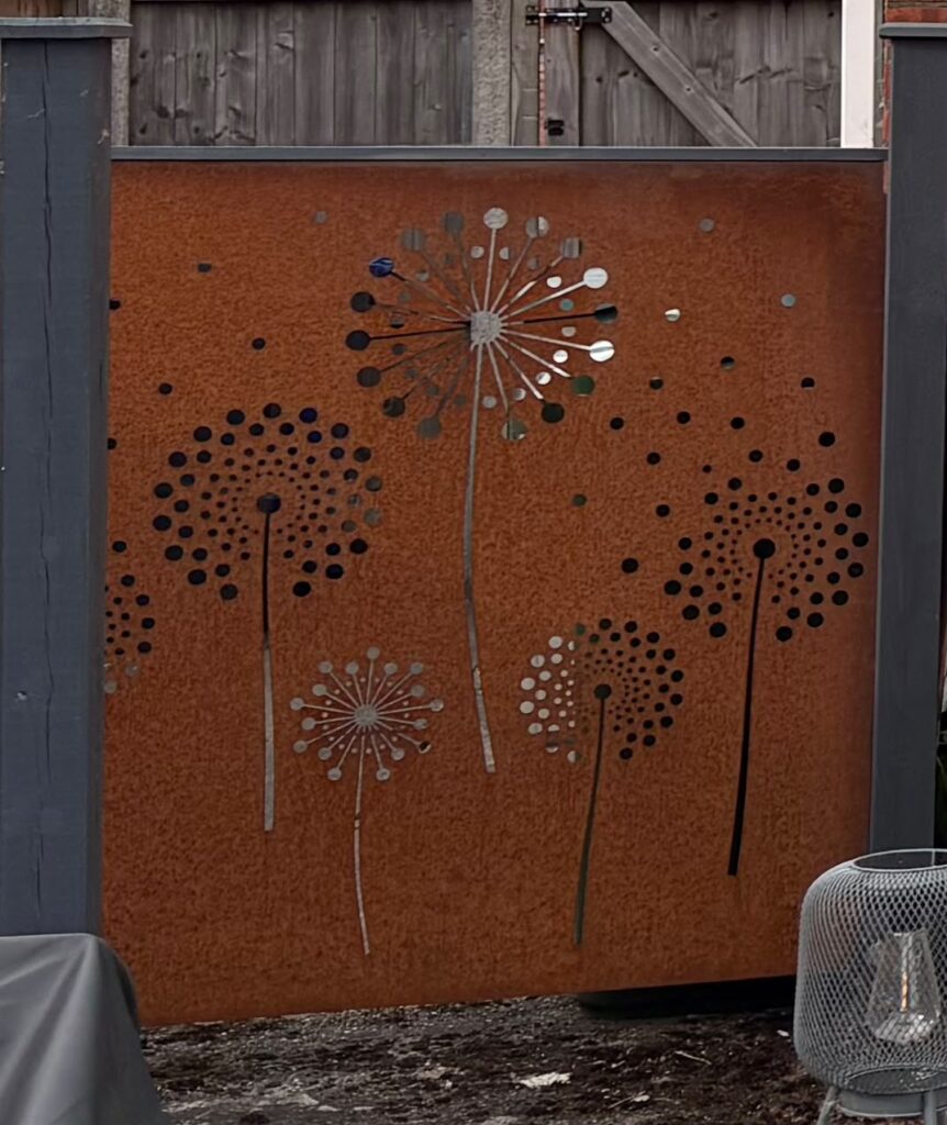a photo to show a mild steel decorative screen with fairy clock pattern cut on our lasers