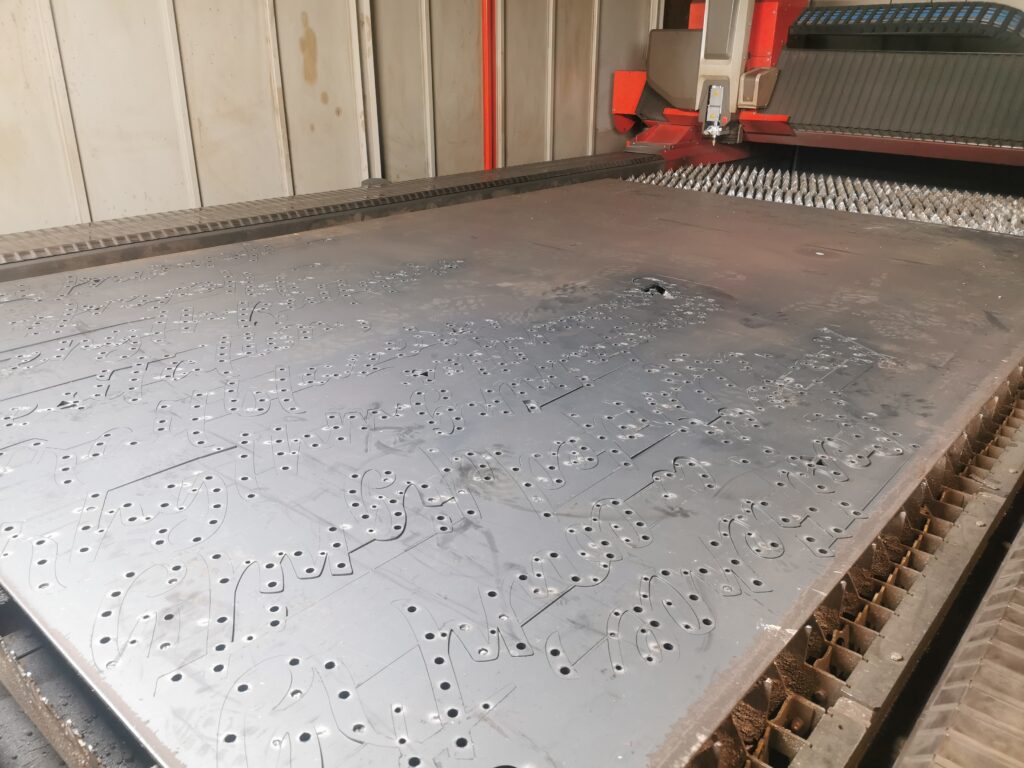 a photo showing some corten cut on our laser machine bed while its silvery grey