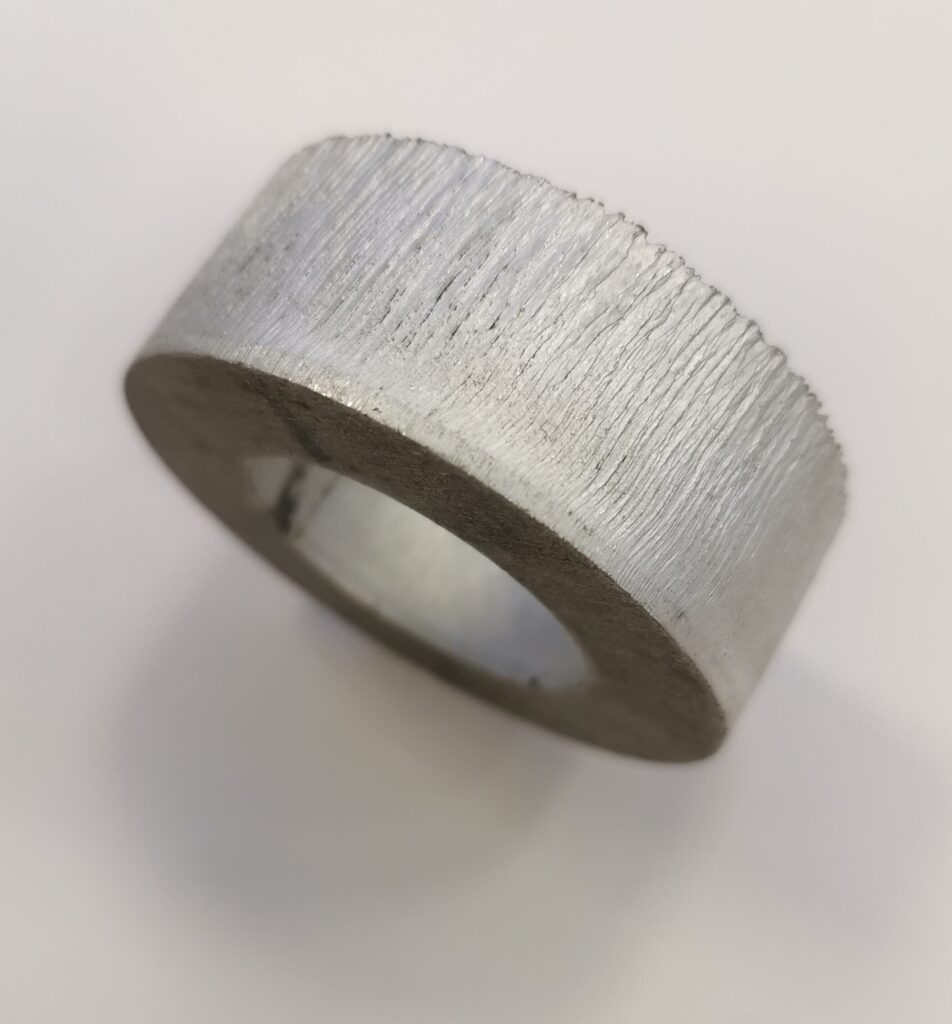 An image showing a 20mm aluminium ring laser cut at Midtherm Laser limited with edge striations from the laser beam